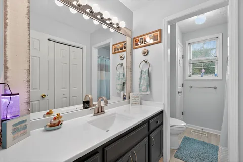 a bathroom with a sink double vanity granite tub and shower