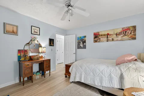 a bedroom with a bed and wooden floor