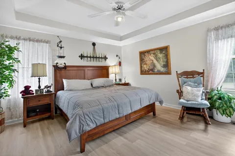 a bedroom with bed and a chandelier