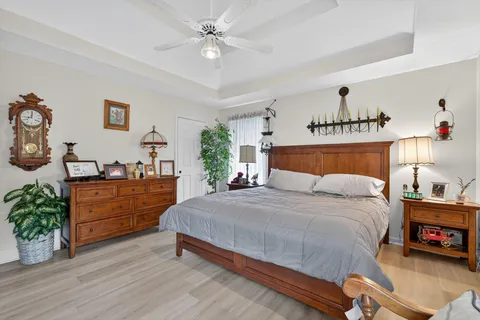 a bedroom with a bed and a chandelier