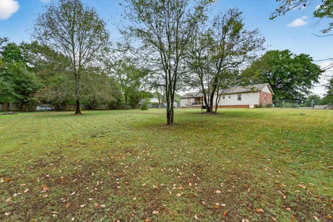 a big yard with lots of green space and trees