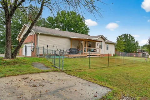 a view of a house with a yard and sitting area
