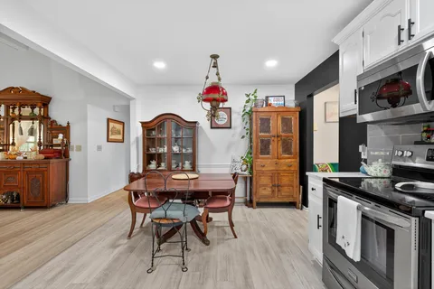 a kitchen that has a table and chairs in it
