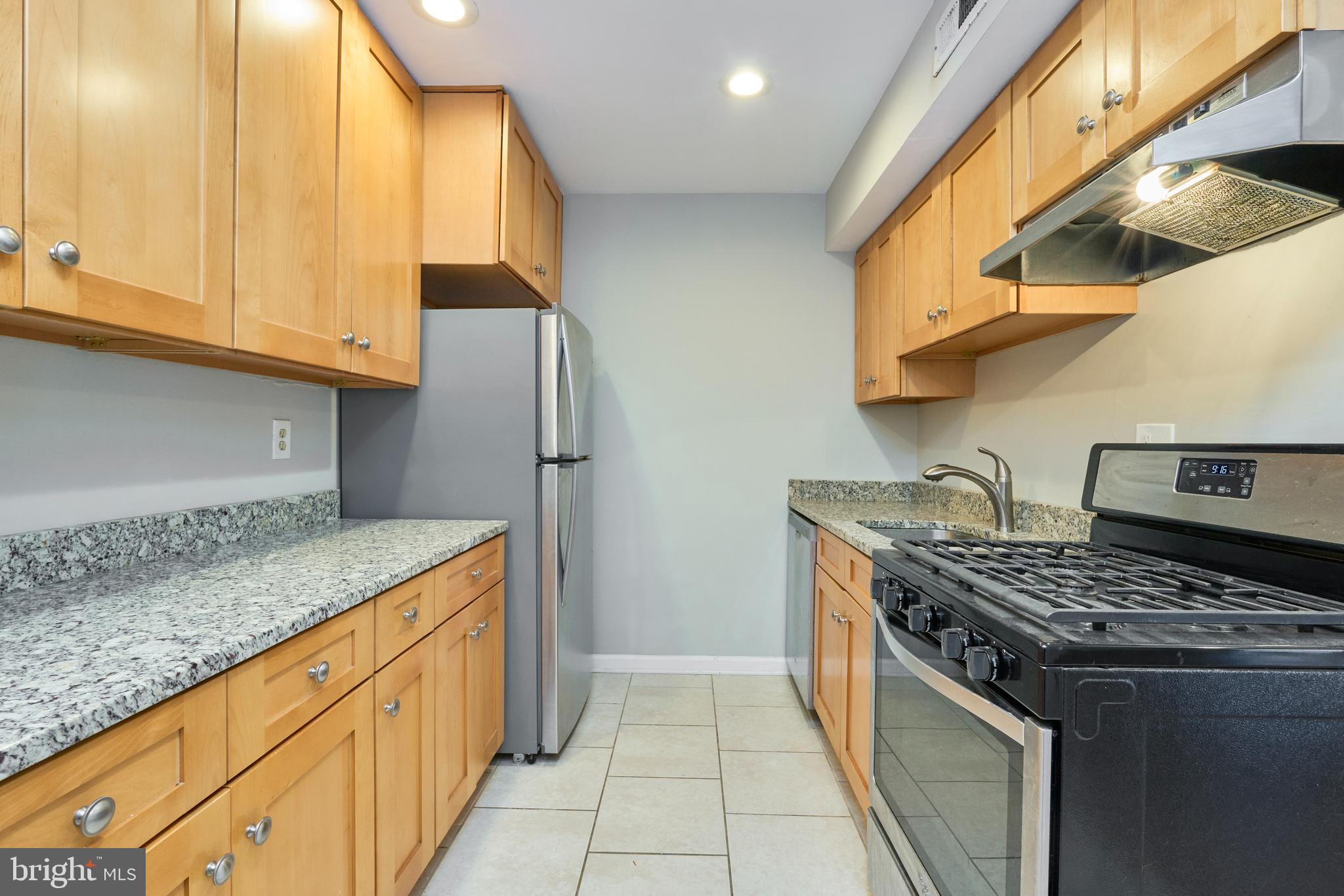 156 Haycock Road, Unit A6 Falls Church, VA 22046 - Photo 13 of 32 a kitchen with stainless steel appliances granite countertop a sink and a stove