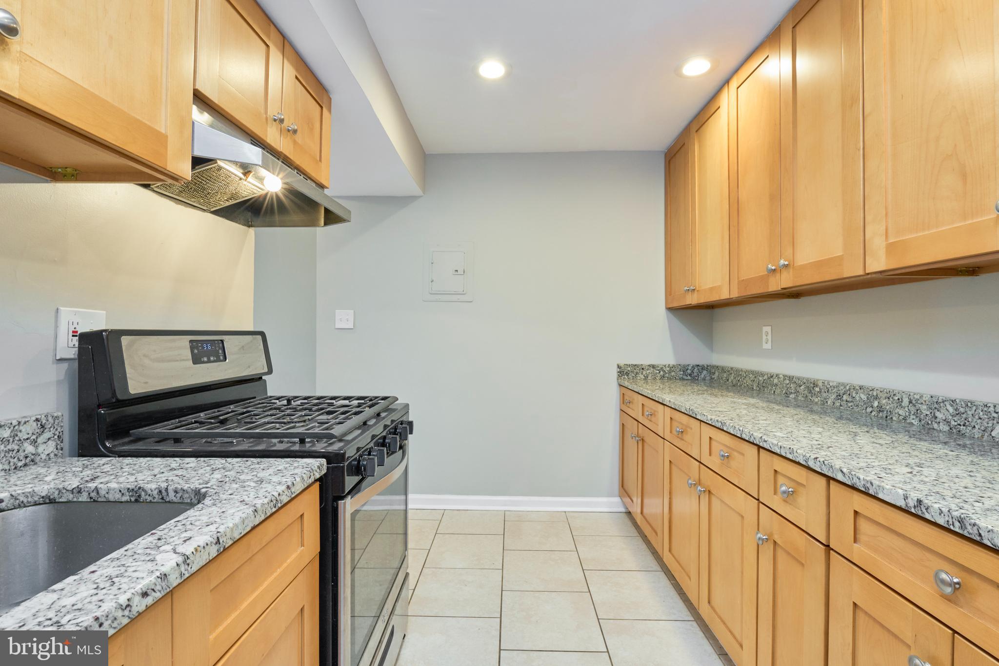 156 Haycock Road, Unit A6 Falls Church, VA 22046 - Photo 15 of 32 a kitchen that has a sink and a stove
