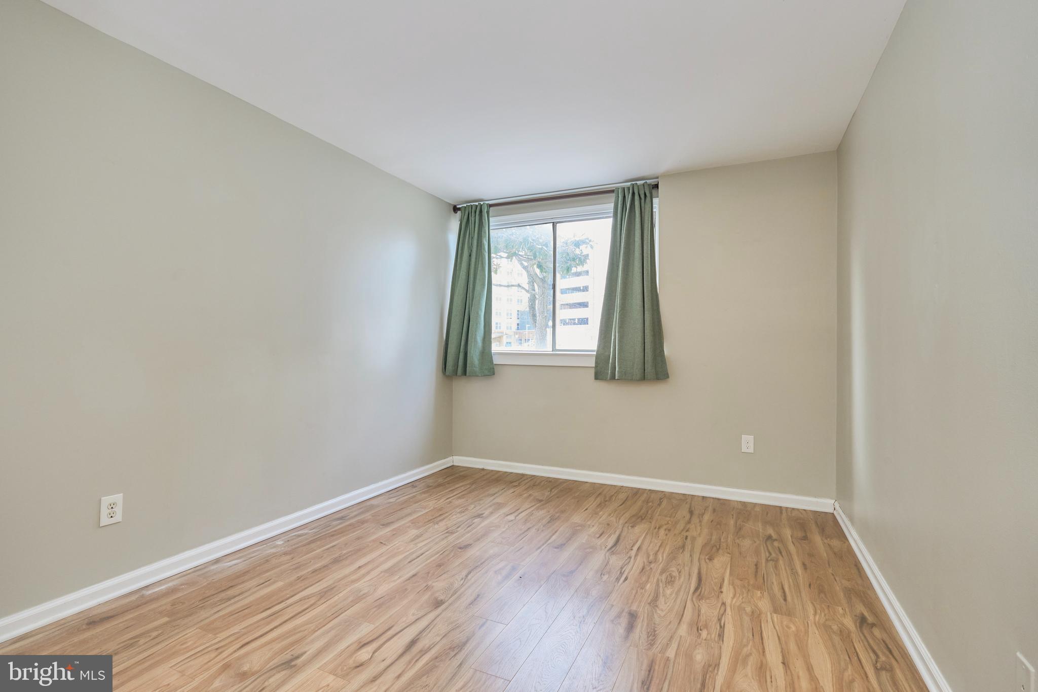 156 Haycock Road, Unit A6 Falls Church, VA 22046 - Photo 18 of 32 an empty room with wooden floor and windows