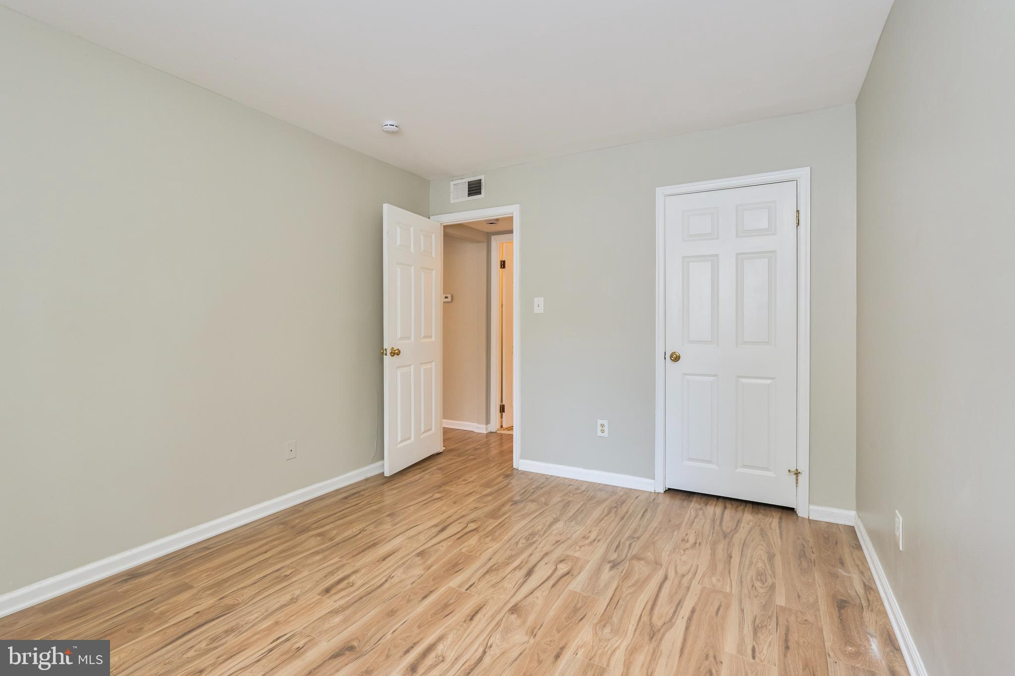 156 Haycock Road, Unit A6 Falls Church, VA 22046 - Photo 19 of 32 a view of an empty room with wooden floor