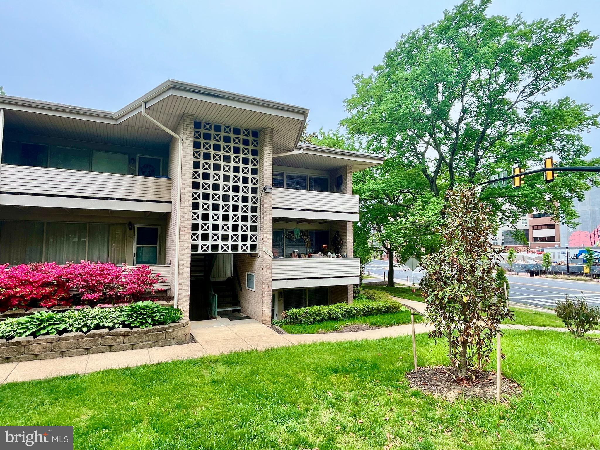 156 Haycock Road, Unit A6 Falls Church, VA 22046 - Photo 2 of 32 a front view of a house with a garden