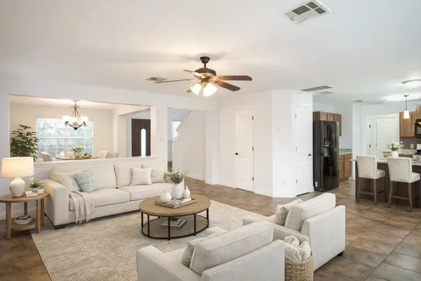 a living room with furniture and a chandelier
