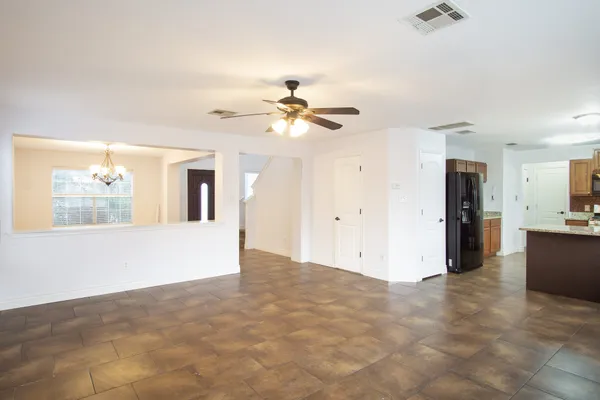a view of a kitchen with cabinet and a ceiling fan
