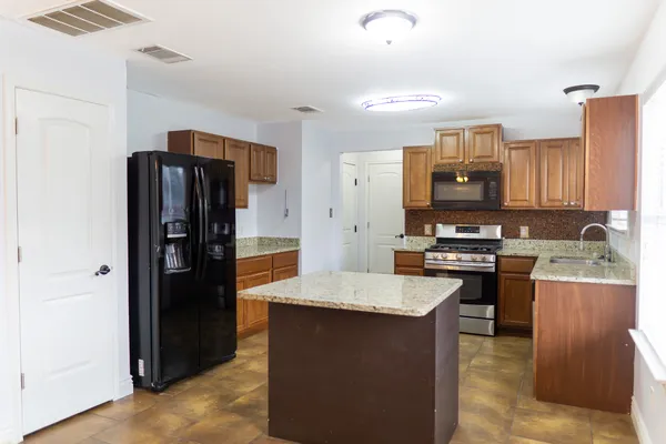a kitchen with stainless steel appliances a refrigerator and a stove