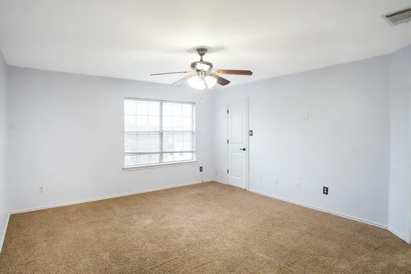 a view of a room with windows and ceiling fan
