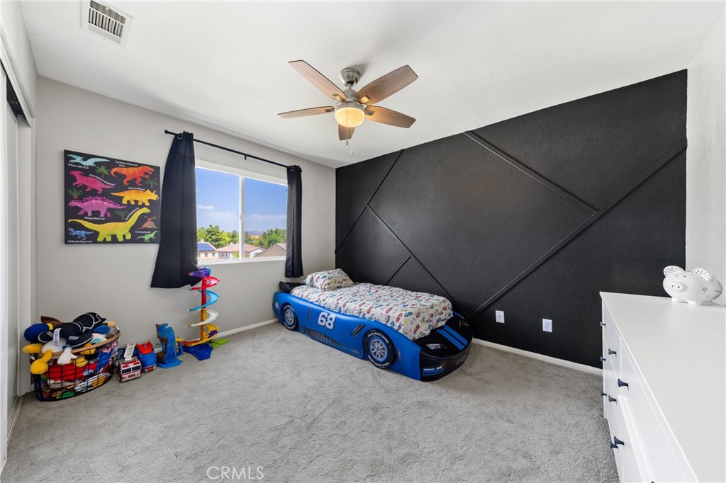 32985 Novara Court Temecula, CA 92592 - Photo 38 of 56 Spacious Bedroom With Accent Wall, Ceiling Fan, And Natural Light