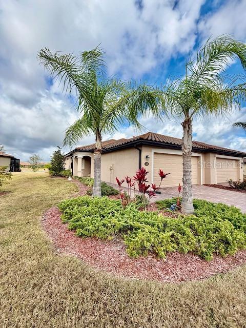 12180 Amica Loop Venice, FL 34293 - Photo 1 of 1 a front view of a house with a yard and a garage