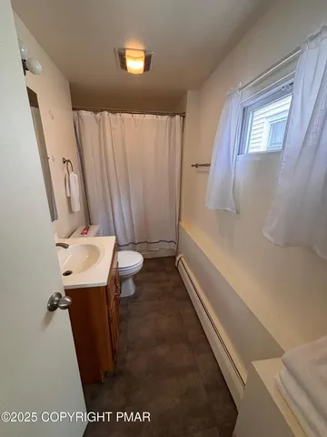 a bathroom with a sink a toilet and a bathtub