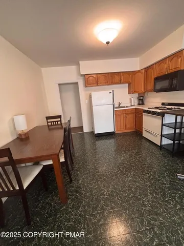 a view of kitchen with sink microwave and cabinets