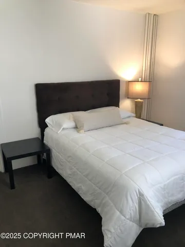 a bedroom with a bed and a night stand