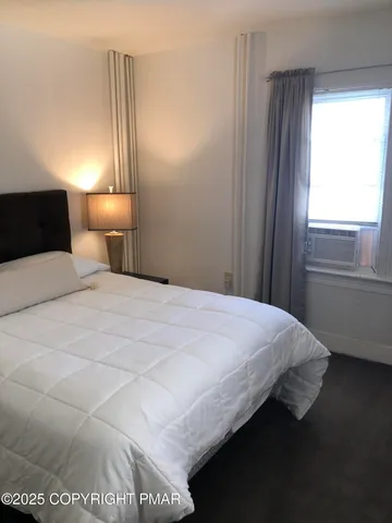 a bedroom with a bed and a night stand