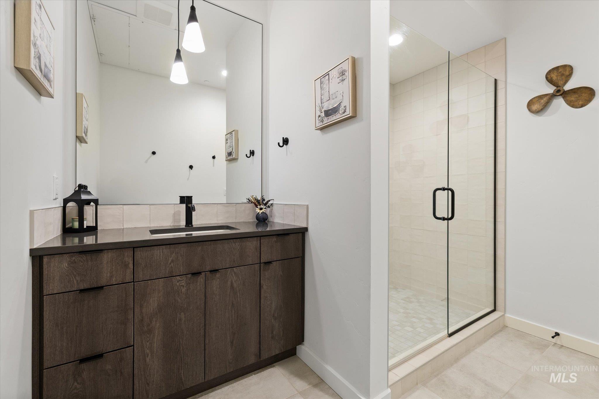 3850 East Haystack Street, Unit 302 Boise, ID 83716 - Photo 16 of 47 Bathroom with vanity, a stall shower, and light tile patterned floors