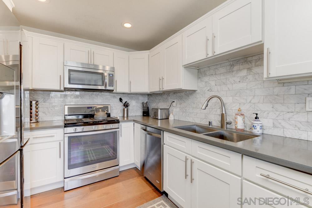 807 Highland Drive Solana Beach, CA 92075 - Photo 9 of 27 a kitchen with stainless steel appliances granite countertop a sink a stove and cabinets