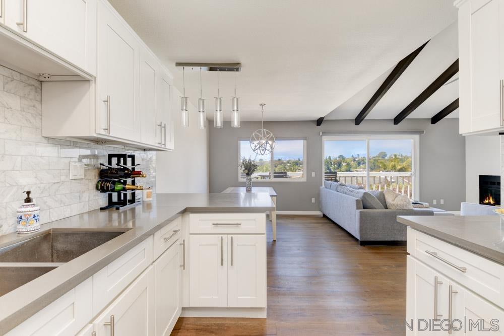 807 Highland Drive Solana Beach, CA 92075 - Photo 10 of 27 a kitchen with white cabinets and wooden floors
