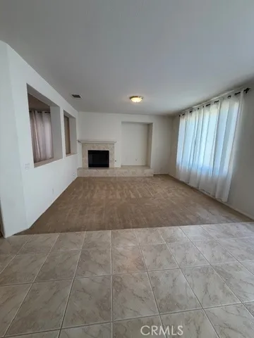 a view of a hallway to a livingroom with a furniture