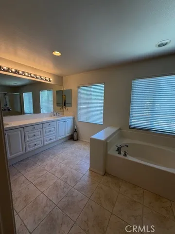 a bathroom with a double vanity sink and a mirror