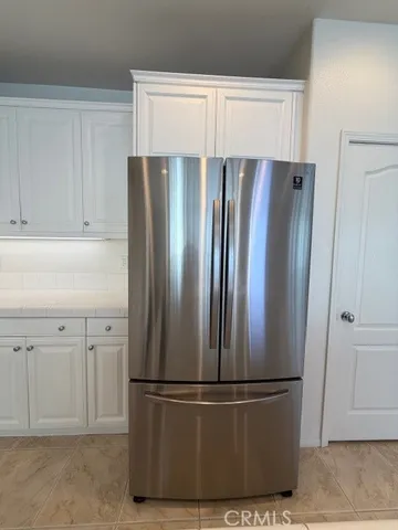 a white refrigerator freezer sitting in a kitchen