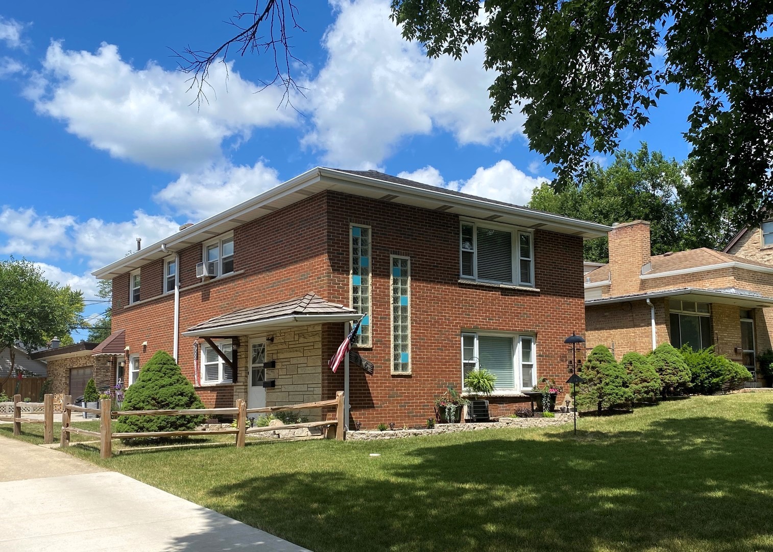 a front view of a house with a yard table and chairs
