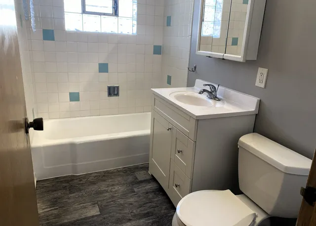 a bathroom with a sink a toilet and bathtub