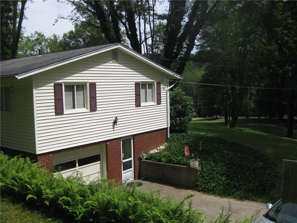1068 Leesburg Station Road Volant, PA 16156 - Photo 2 of 25 Landscaping very attractive...basement entry.