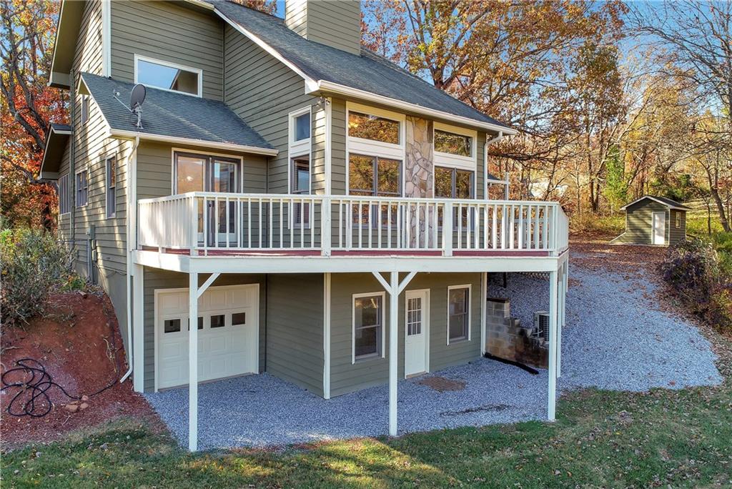 a view of a house with a yard and deck