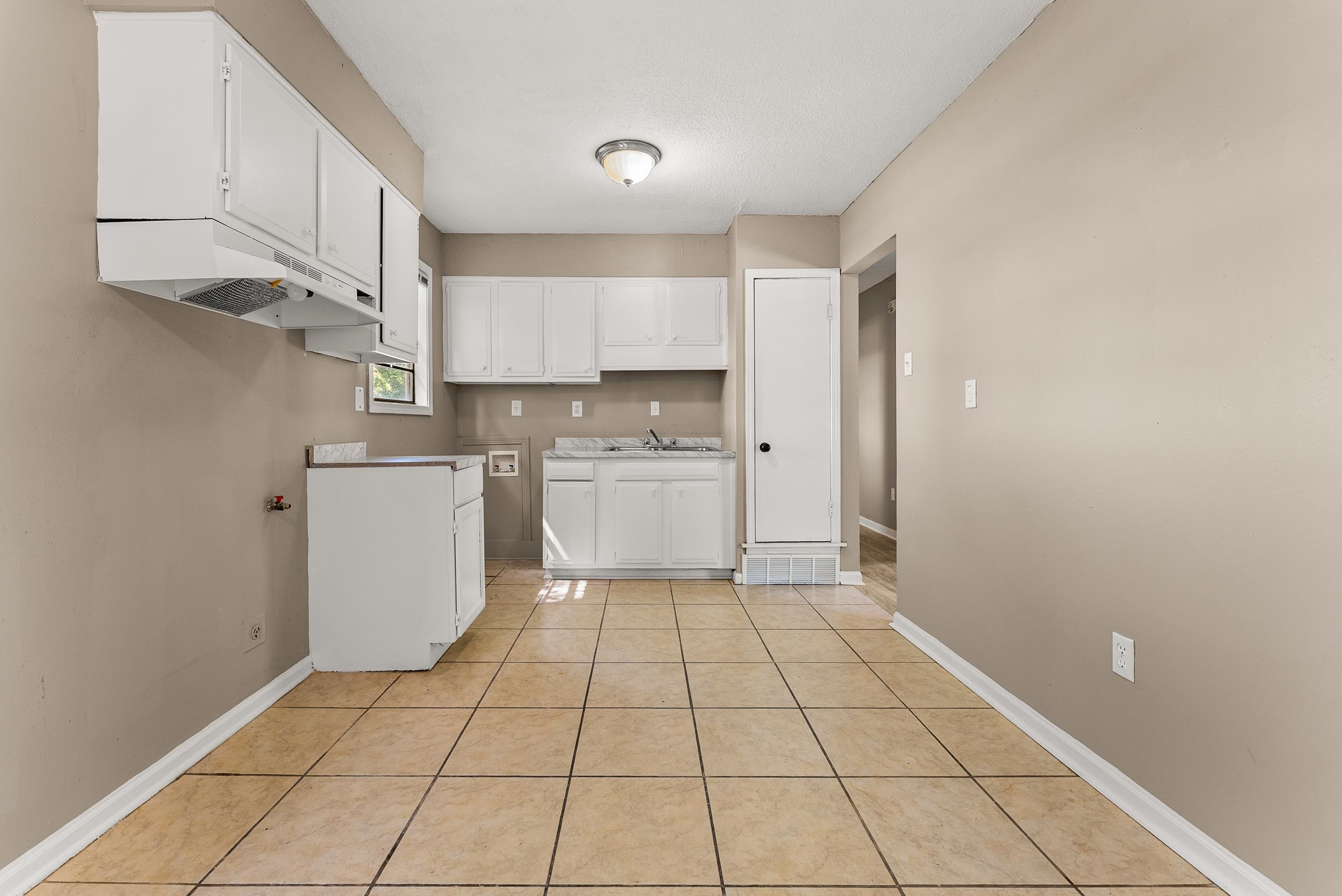 3759 McCain Road Memphis, TN 38109 - Photo 11 of 30 a kitchen with a sink a stove and cabinets