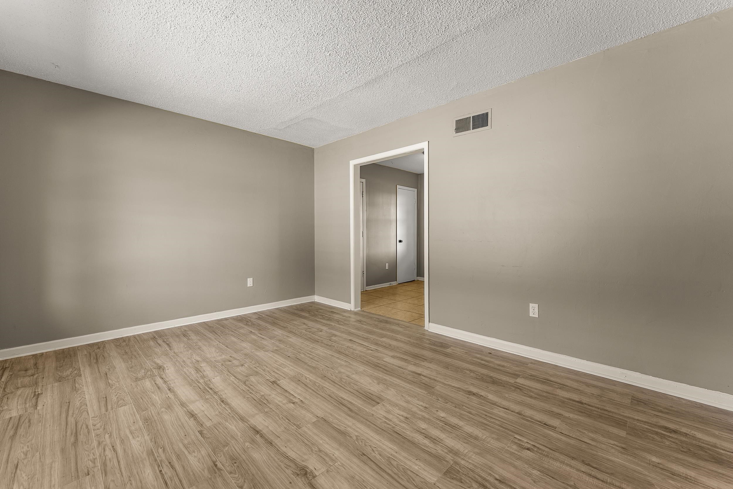 3759 McCain Road Memphis, TN 38109 - Photo 7 of 30 a view of an empty room with wooden floor and closet
