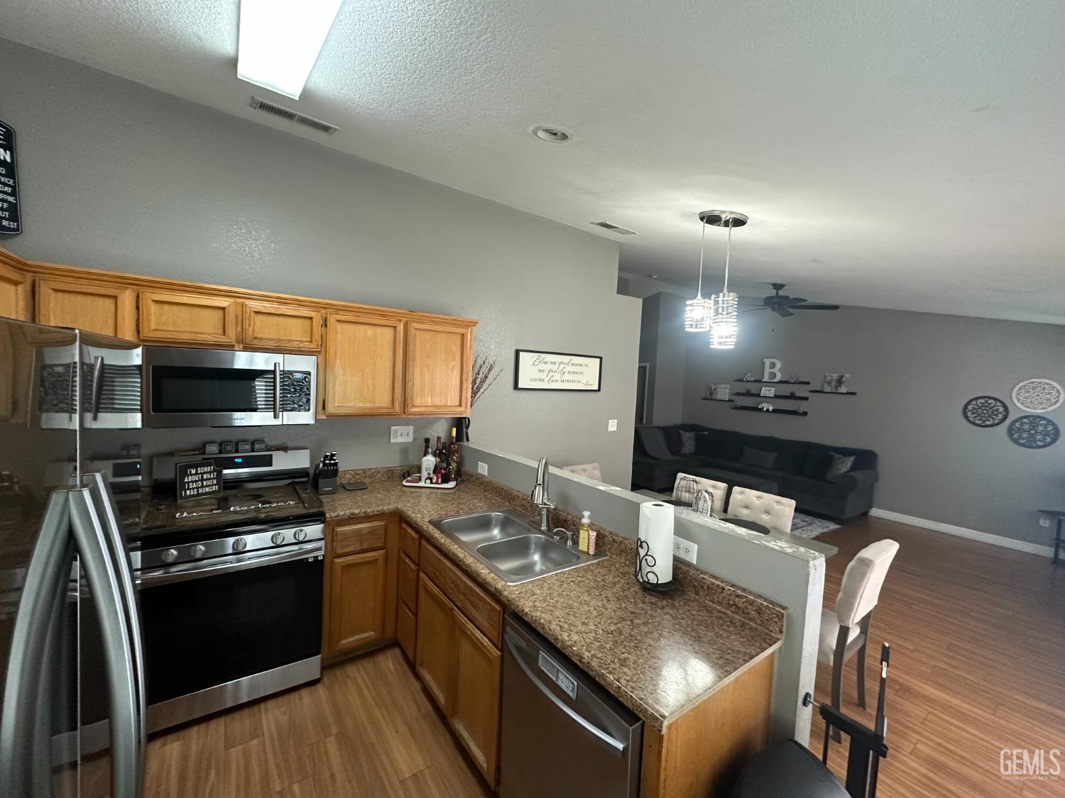 Undisclosed Address Bakersfield, CA 93307 - Photo 11 of 15 a kitchen with a stove a sink and a microwave