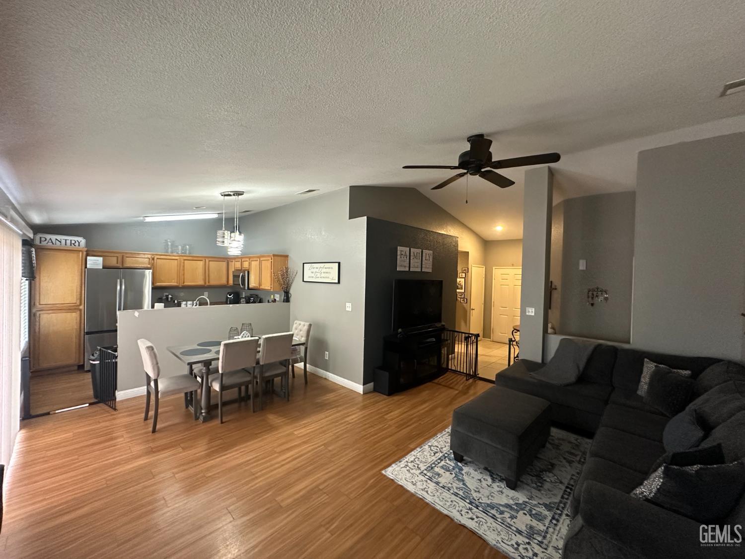 Undisclosed Address Bakersfield, CA 93307 - Photo 13 of 15 a living room with furniture and a wooden floor