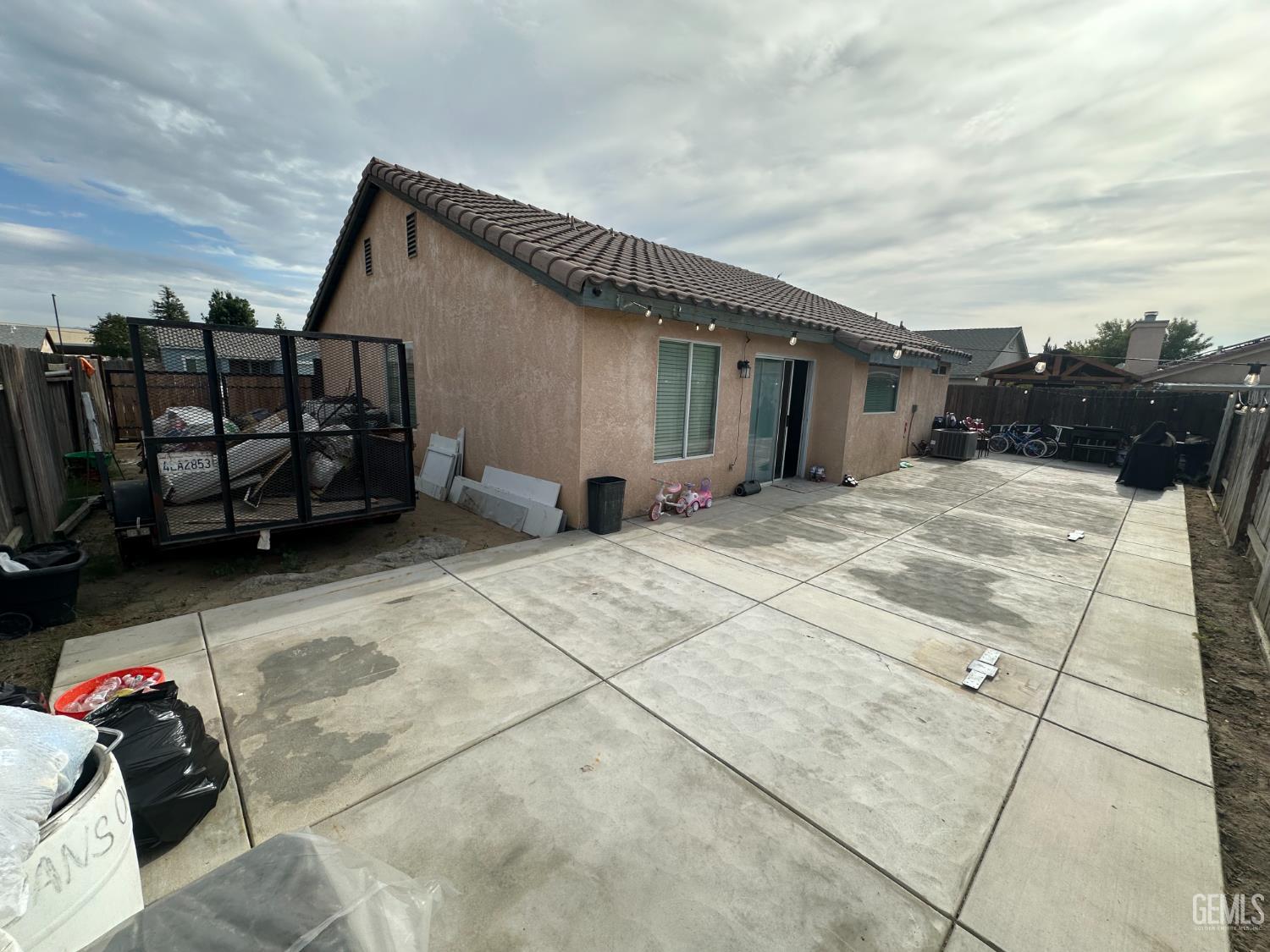 Undisclosed Address Bakersfield, CA 93307 - Photo 14 of 15 a backyard of a house with barbeque oven and outdoor seating