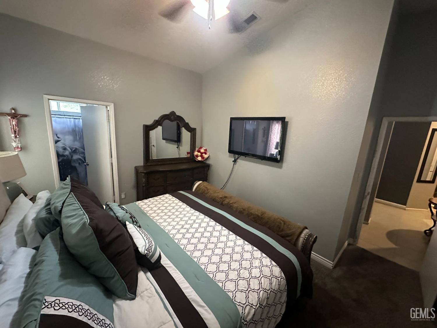 Undisclosed Address Bakersfield, CA 93307 - Photo 6 of 15 a bedroom with a bed and a mirror