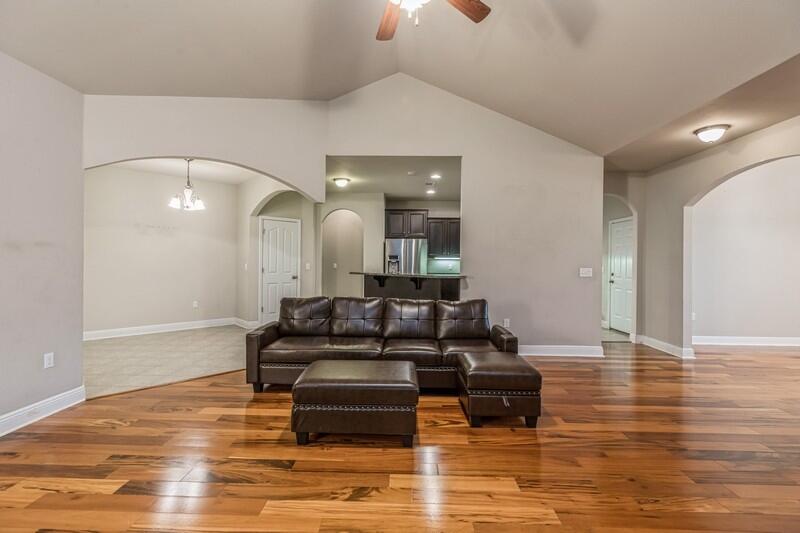 516 Pheasant Trail Crestview, FL 32536 - Photo 13 of 38 a living room with furniture and a wooden floor