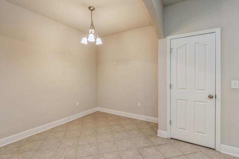 516 Pheasant Trail Crestview, FL 32536 - Photo 16 of 38 a view of a chandelier in an empty room