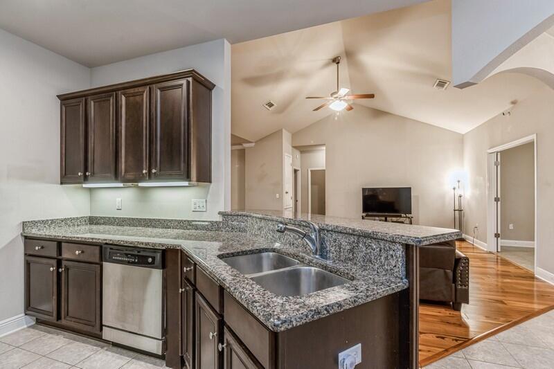 516 Pheasant Trail Crestview, FL 32536 - Photo 18 of 38 a kitchen with granite countertop a sink a counter top space appliances and cabinets