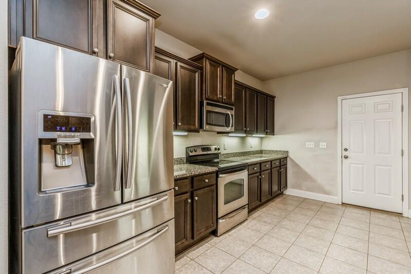 516 Pheasant Trail Crestview, FL 32536 - Photo 19 of 38 a kitchen with stainless steel appliances granite countertop a refrigerator and a stove top oven