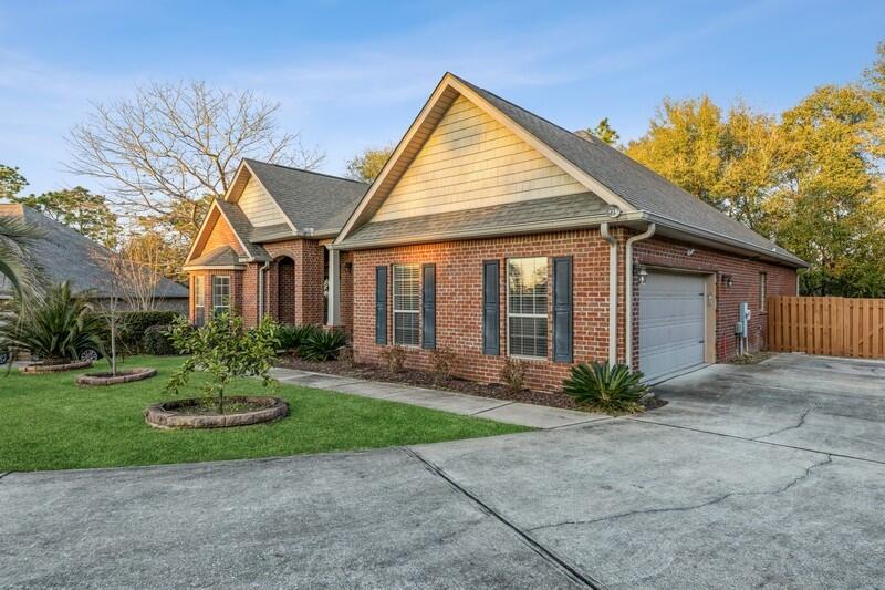 516 Pheasant Trail Crestview, FL 32536 - Photo 2 of 38 a front view of a house with a garden and plants