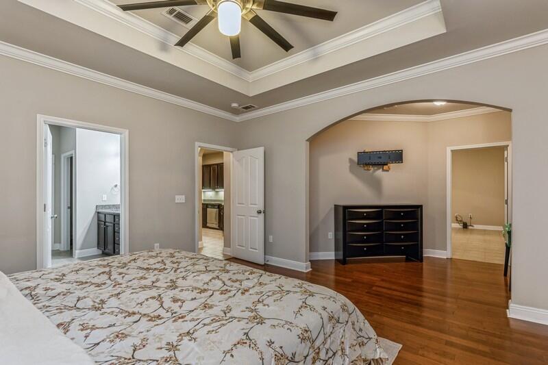 516 Pheasant Trail Crestview, FL 32536 - Photo 22 of 38 a bedroom with bed and wooden floor