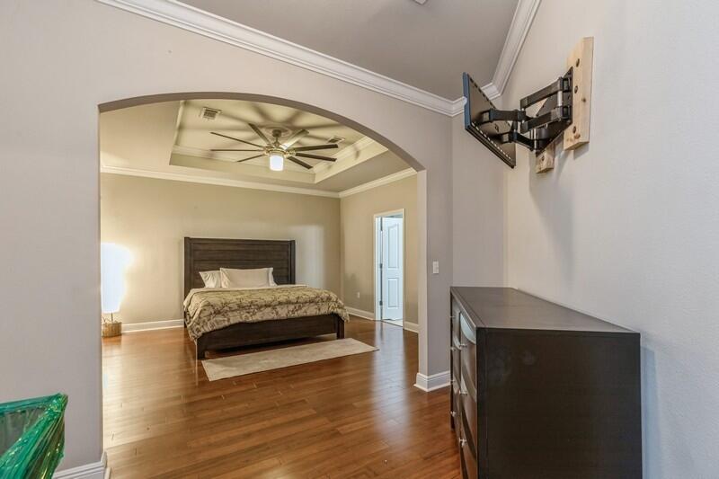 516 Pheasant Trail Crestview, FL 32536 - Photo 23 of 38 a bedroom with a bed and a mirror