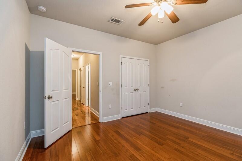 516 Pheasant Trail Crestview, FL 32536 - Photo 29 of 38 wooden floor in an empty room with a window