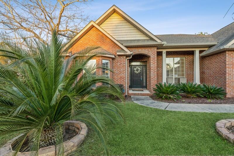 516 Pheasant Trail Crestview, FL 32536 - Photo 3 of 38 a front view of a house with a yard