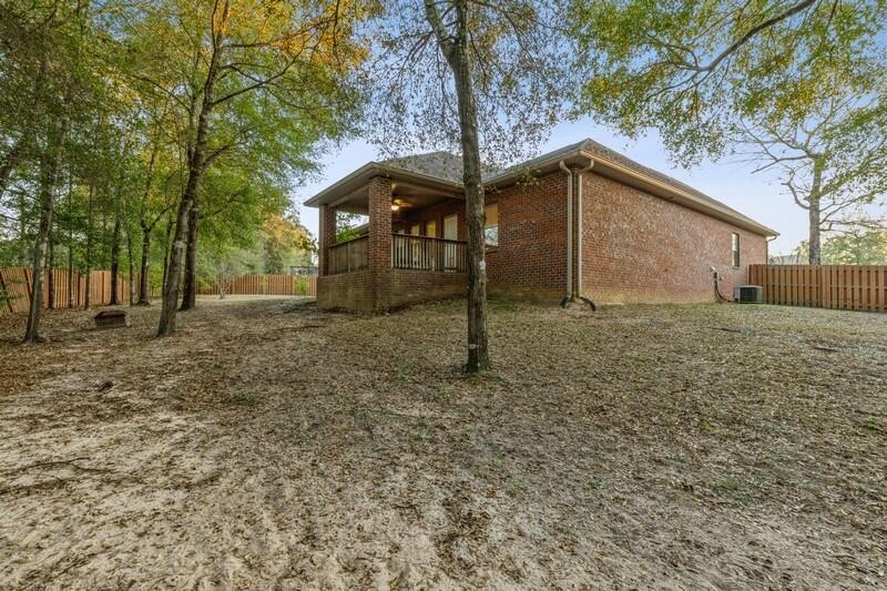 516 Pheasant Trail Crestview, FL 32536 - Photo 35 of 38 a backyard of a house with lots of green space