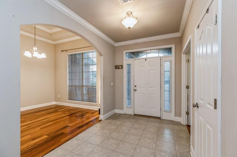 516 Pheasant Trail Crestview, FL 32536 - Photo 4 of 38 a view of an empty room with glass door and a window