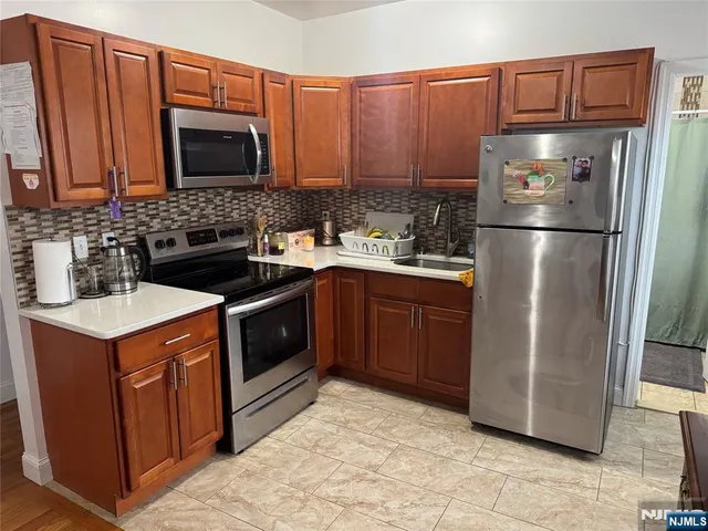 a kitchen with a sink stove and refrigerator
